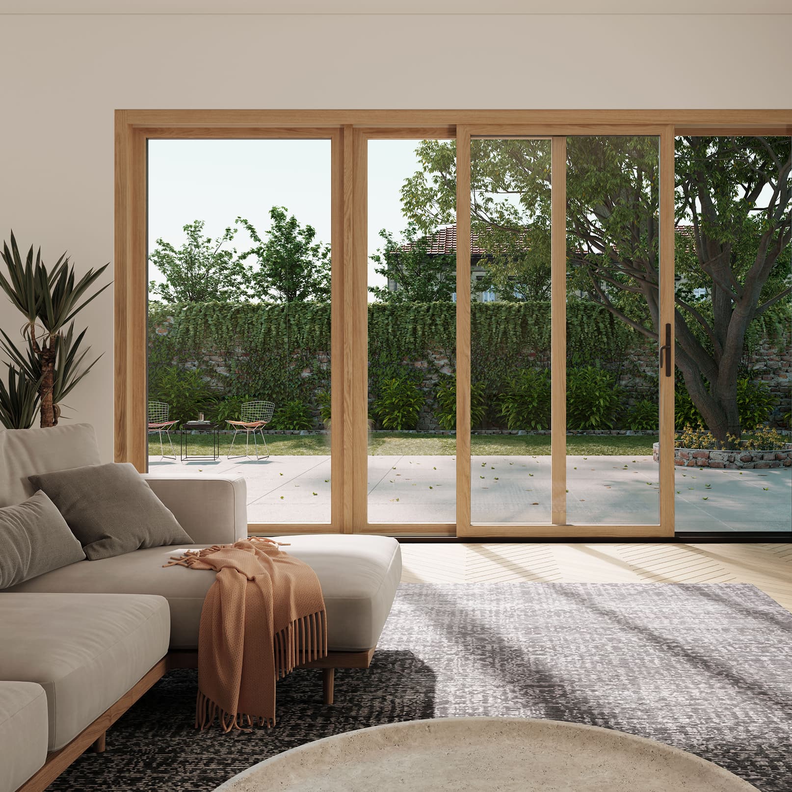 Living room interior view of an opened wood Marvin Elevate Sliding Door leading to a concrete patio.
