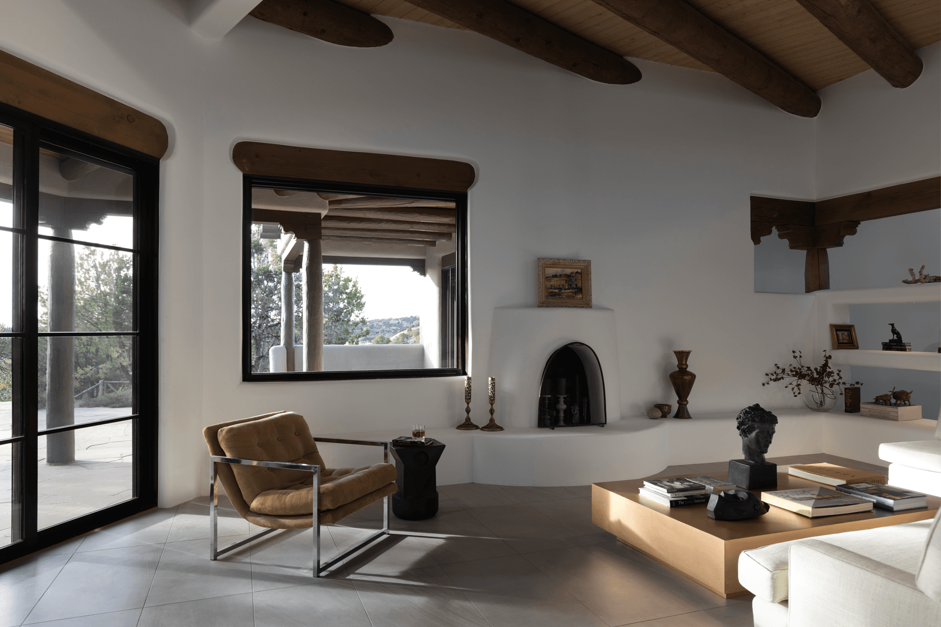 Southwestern style home interior with black Marvin Ultimate Narrow Frame Awning window and two-panel sliding patio door.