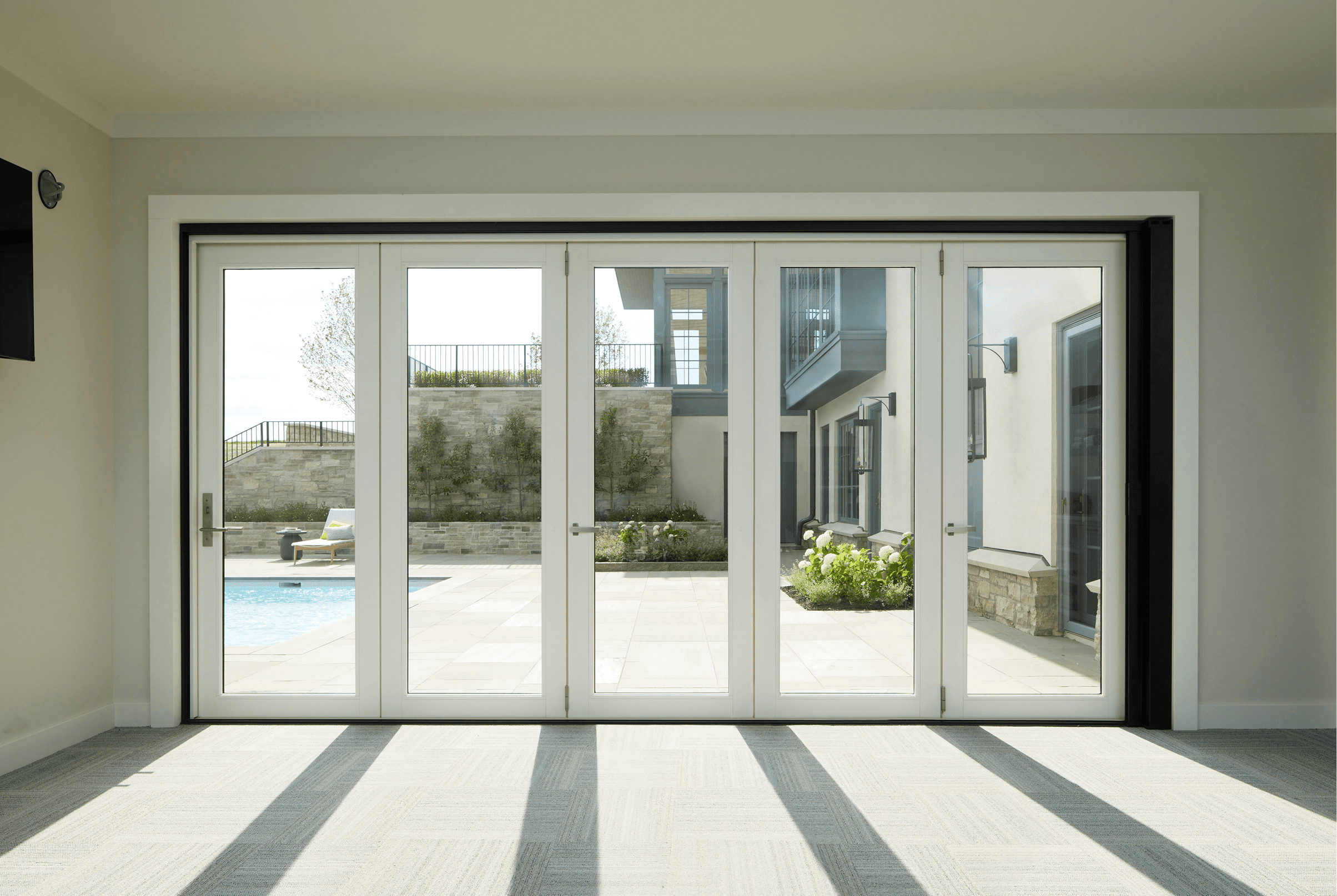 Home interior featuring a closed white Marvin Ultimate Bi-Fold Door.